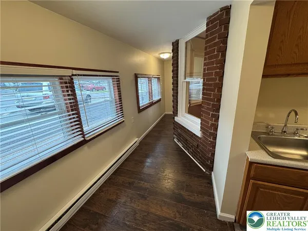 a view of a hallway with furniture