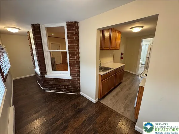 a view of kitchen with cabinets and wooden floor