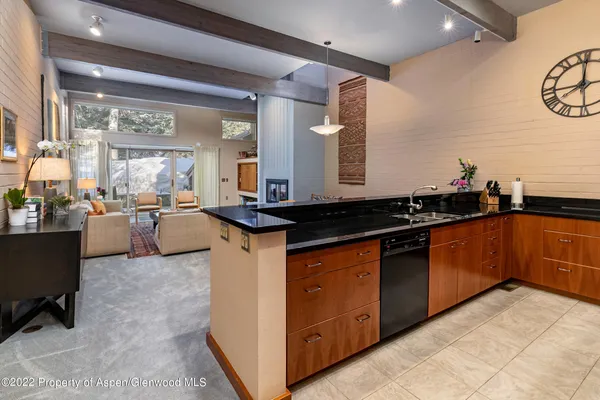 a kitchen with granite countertop a sink and a stove top oven