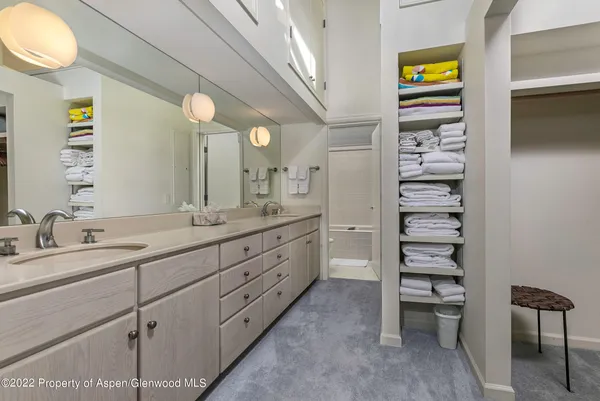 a spacious bathroom with a double vanity sink and a mirror
