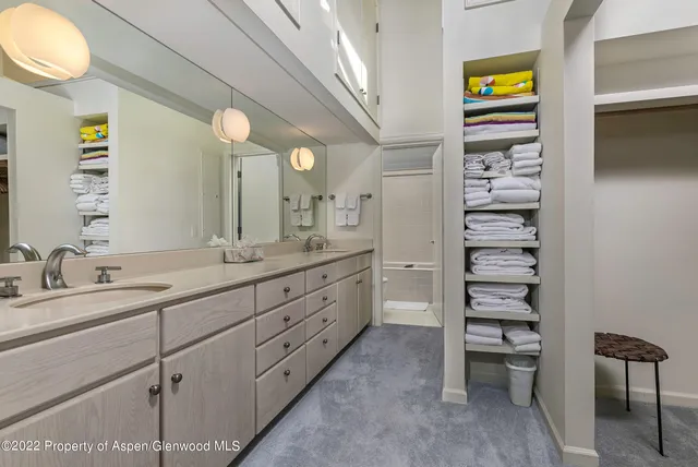 a spacious bathroom with a double vanity sink and a mirror