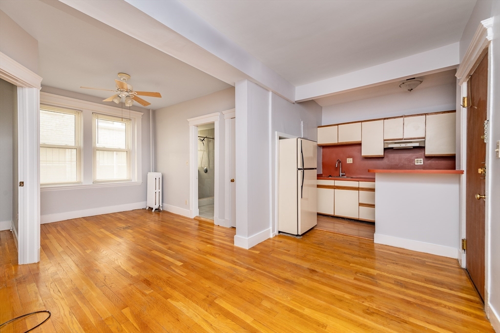 31 Orkney Road, Unit 5 Boston, MA 02135 - Photo 1 of 8 a view of a kitchen with wooden floor electronic appliances and window