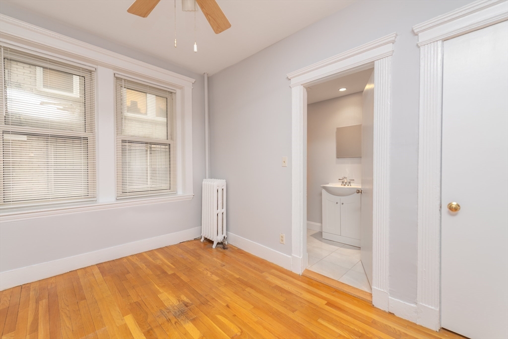 31 Orkney Road, Unit 5 Boston, MA 02135 - Photo 5 of 8 a view of empty room with wooden floor and windows