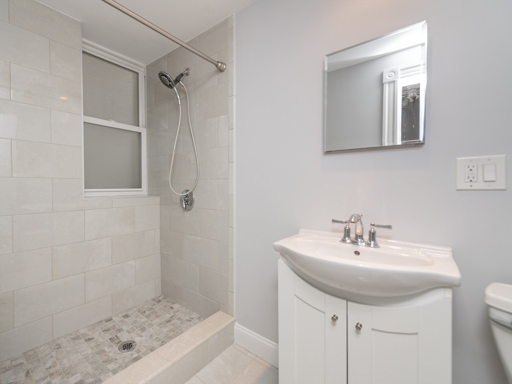31 Orkney Road, Unit 5 Boston, MA 02135 - Photo 6 of 8 a bathroom with a sink a toilet and shower