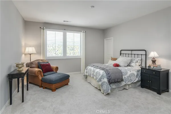 a spacious bedroom with a bed and a couch