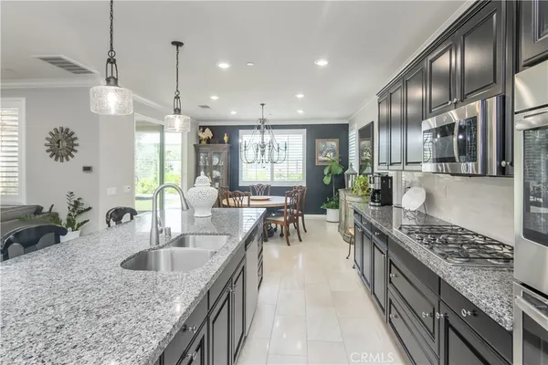a kitchen with counter top space a sink stainless steel appliances and cabinets