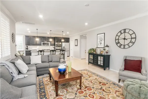 a living room with furniture and kitchen view