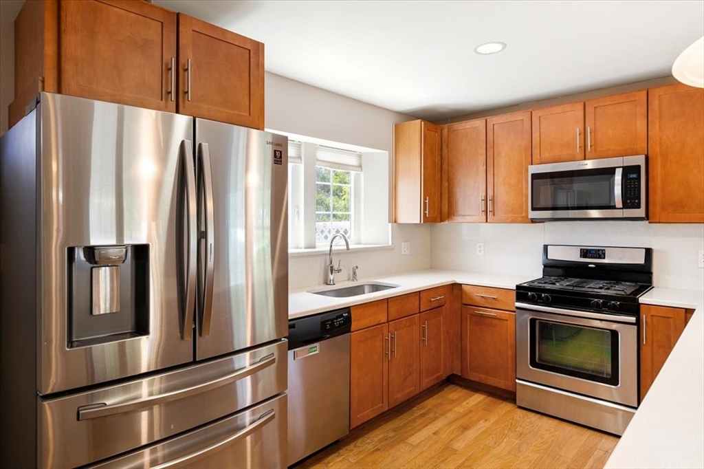 6 Bates Street, Unit A Devens, MA 01434 - Photo 18 of 41 a kitchen with stainless steel appliances a refrigerator sink and microwave