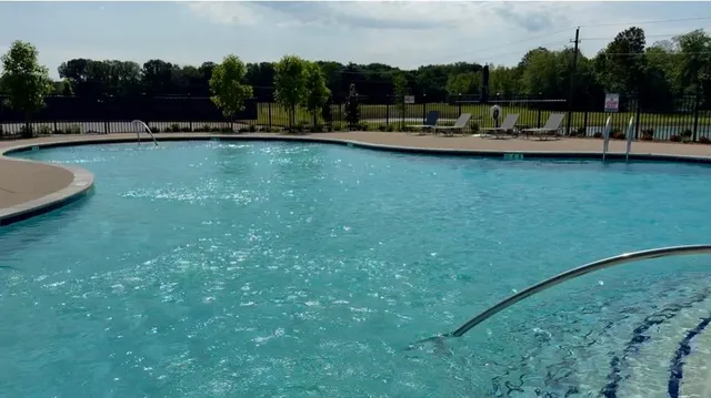 a view of a swimming pool and a yard
