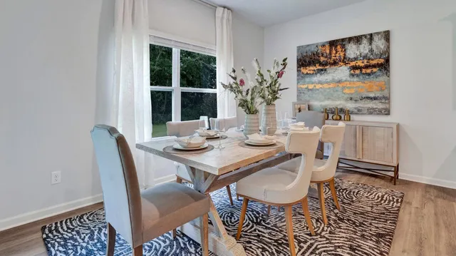a view of a dining room with furniture window and wooden floor