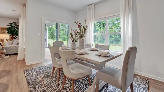 a dining room with furniture wooden floor and a rug