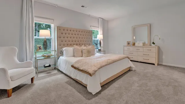 a spacious bedroom with a bed and a couch