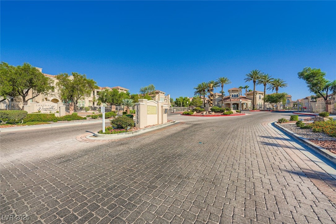 10550 West Alexander Road, Unit 2219 Las Vegas, NV 89129 - Photo 25 of 29 View of road with a residential view, curbs, and a gated entry