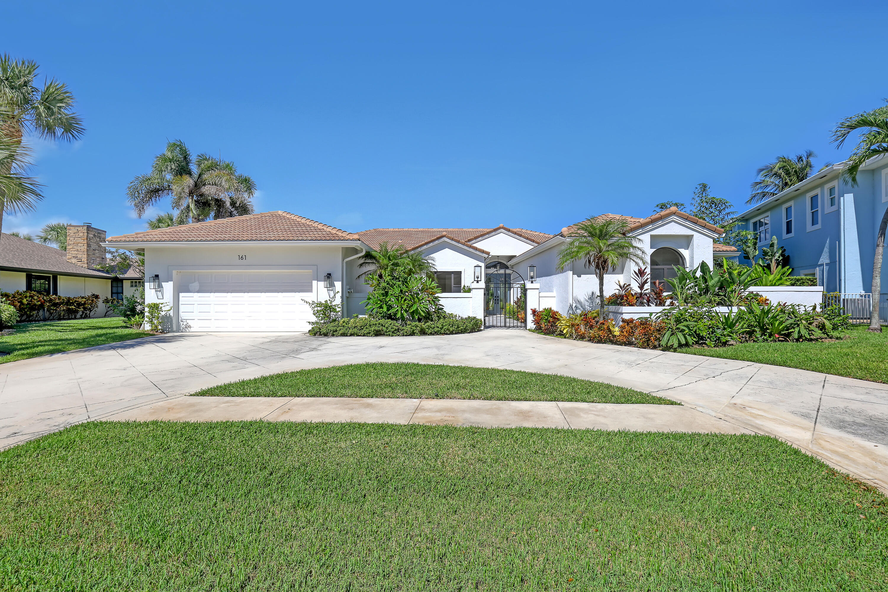 161 Apollo Circle Jupiter, FL 33477 - Photo 13 of 60 a front view of a house with a yard
