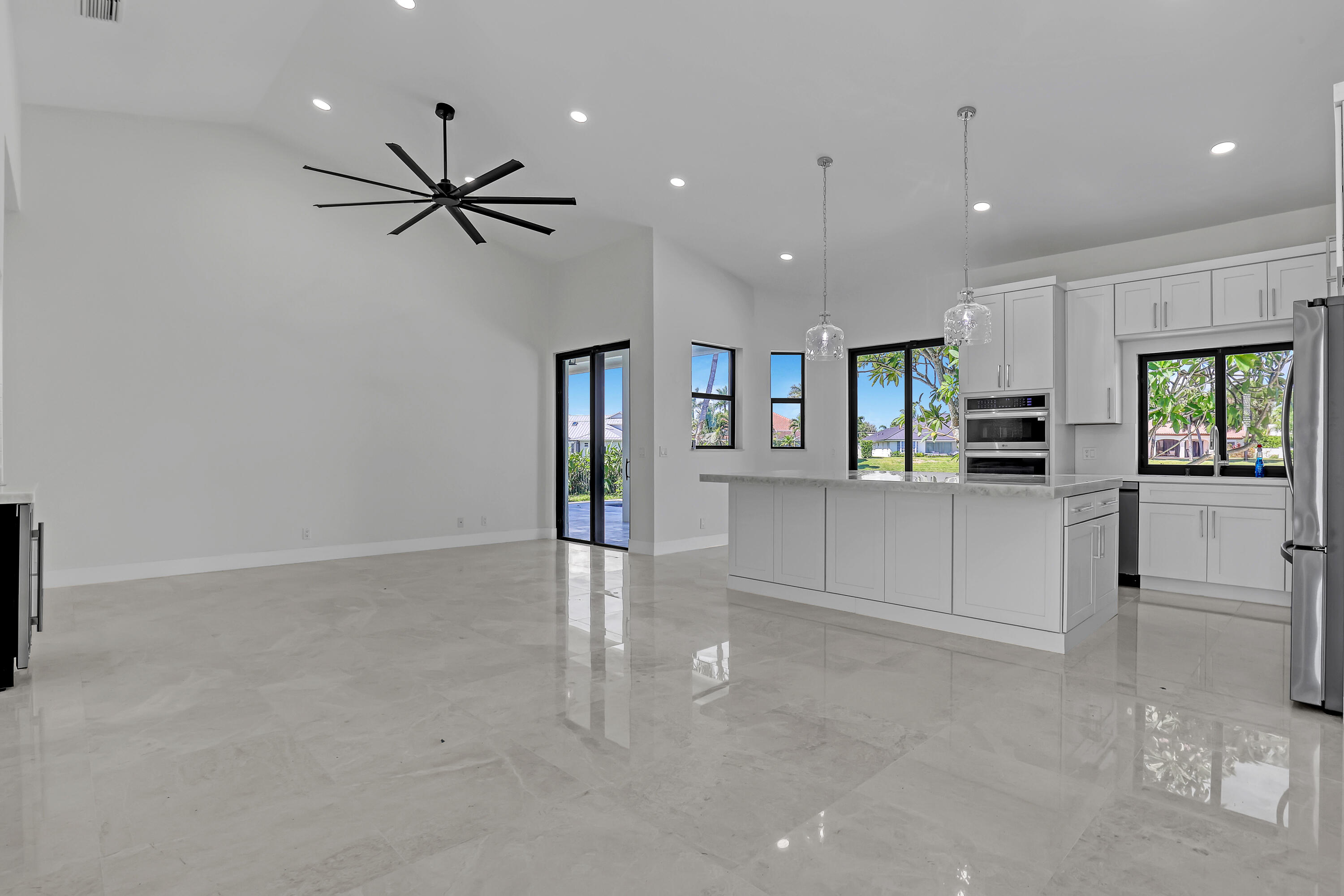 161 Apollo Circle Jupiter, FL 33477 - Photo 15 of 60 a view of a kitchen with refrigerator and a stove top oven