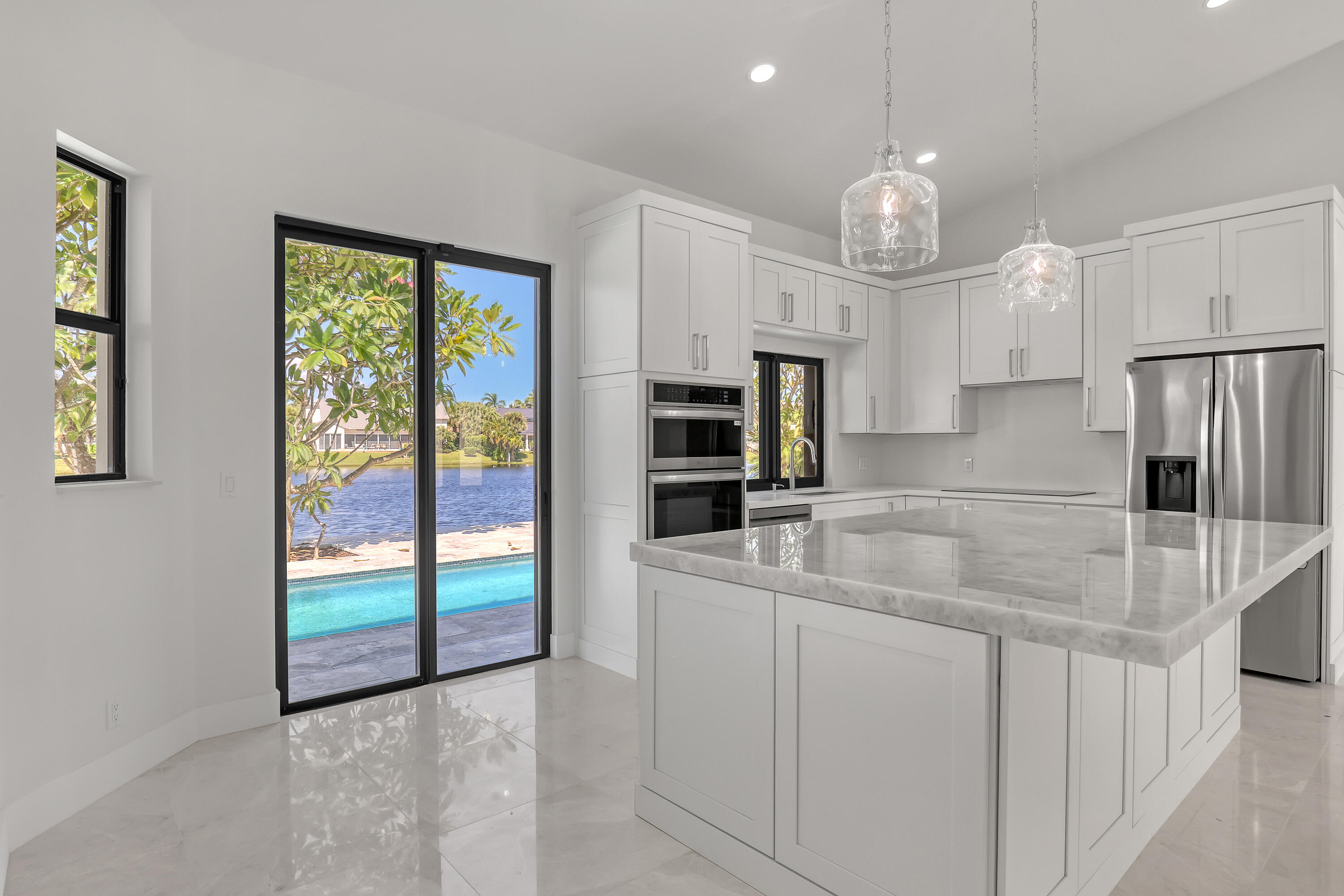 161 Apollo Circle Jupiter, FL 33477 - Photo 17 of 60 a kitchen with stainless steel appliances granite countertop a sink and a refrigerator