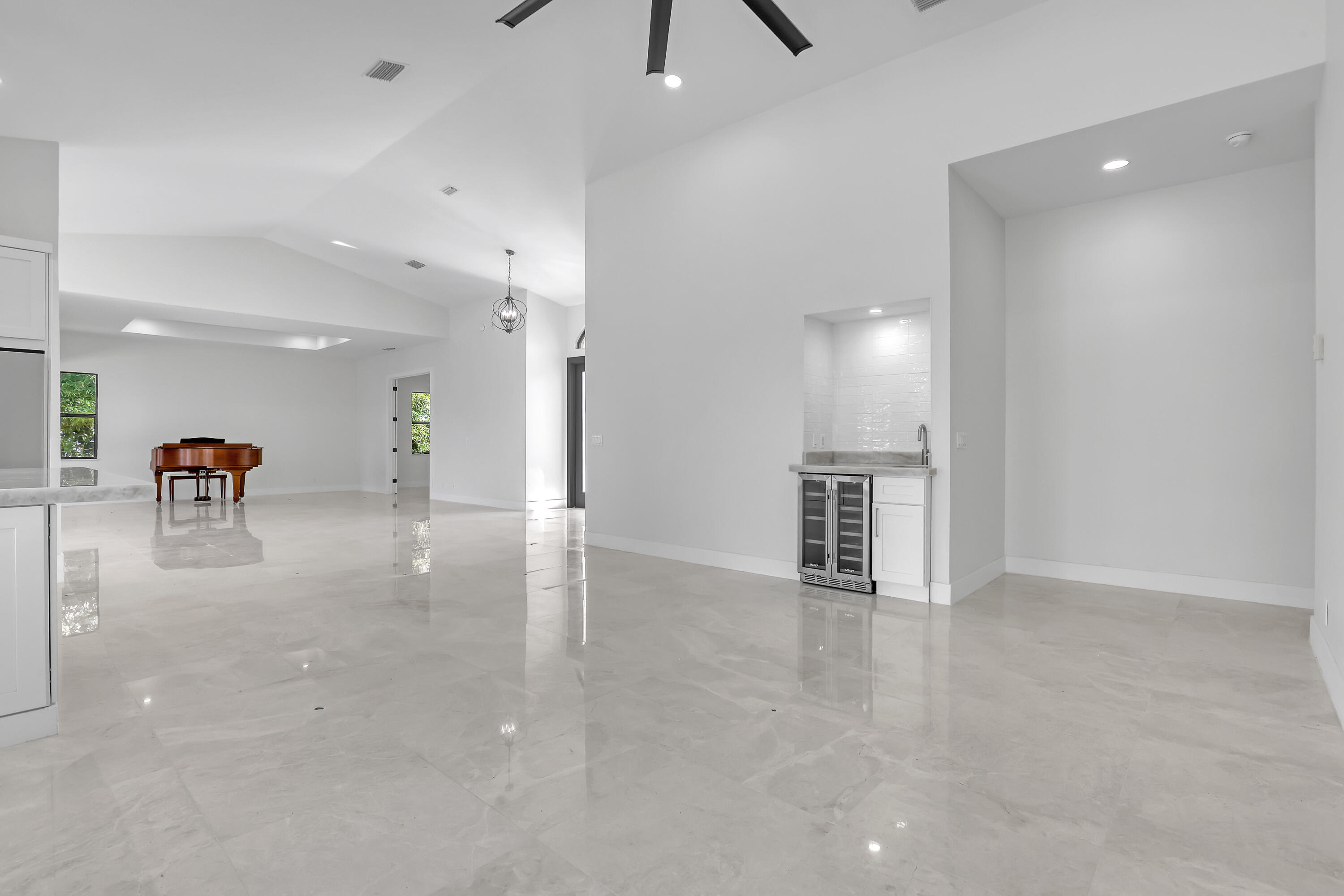 161 Apollo Circle Jupiter, FL 33477 - Photo 23 of 60 a view of an empty room and a kitchen