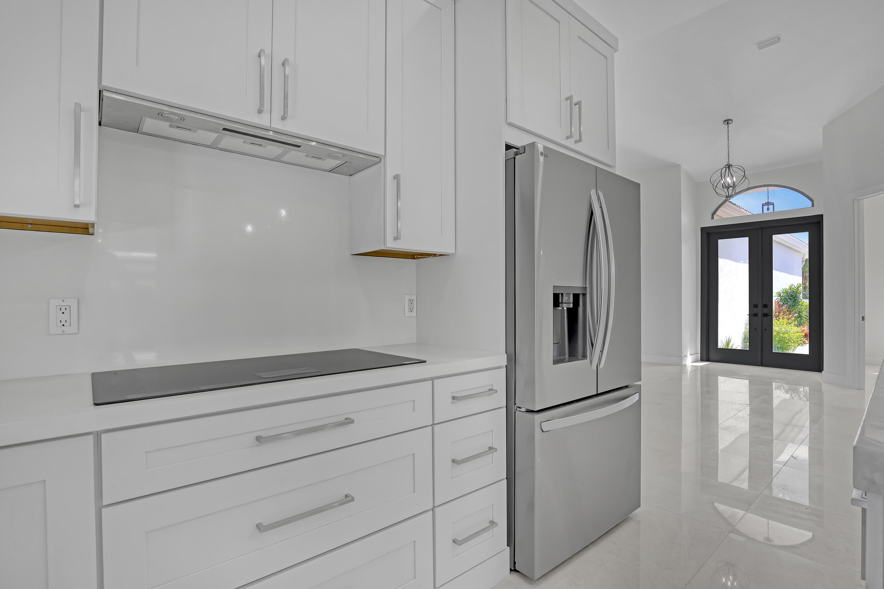 161 Apollo Circle Jupiter, FL 33477 - Photo 25 of 60 a kitchen with cabinets and stainless steel appliances