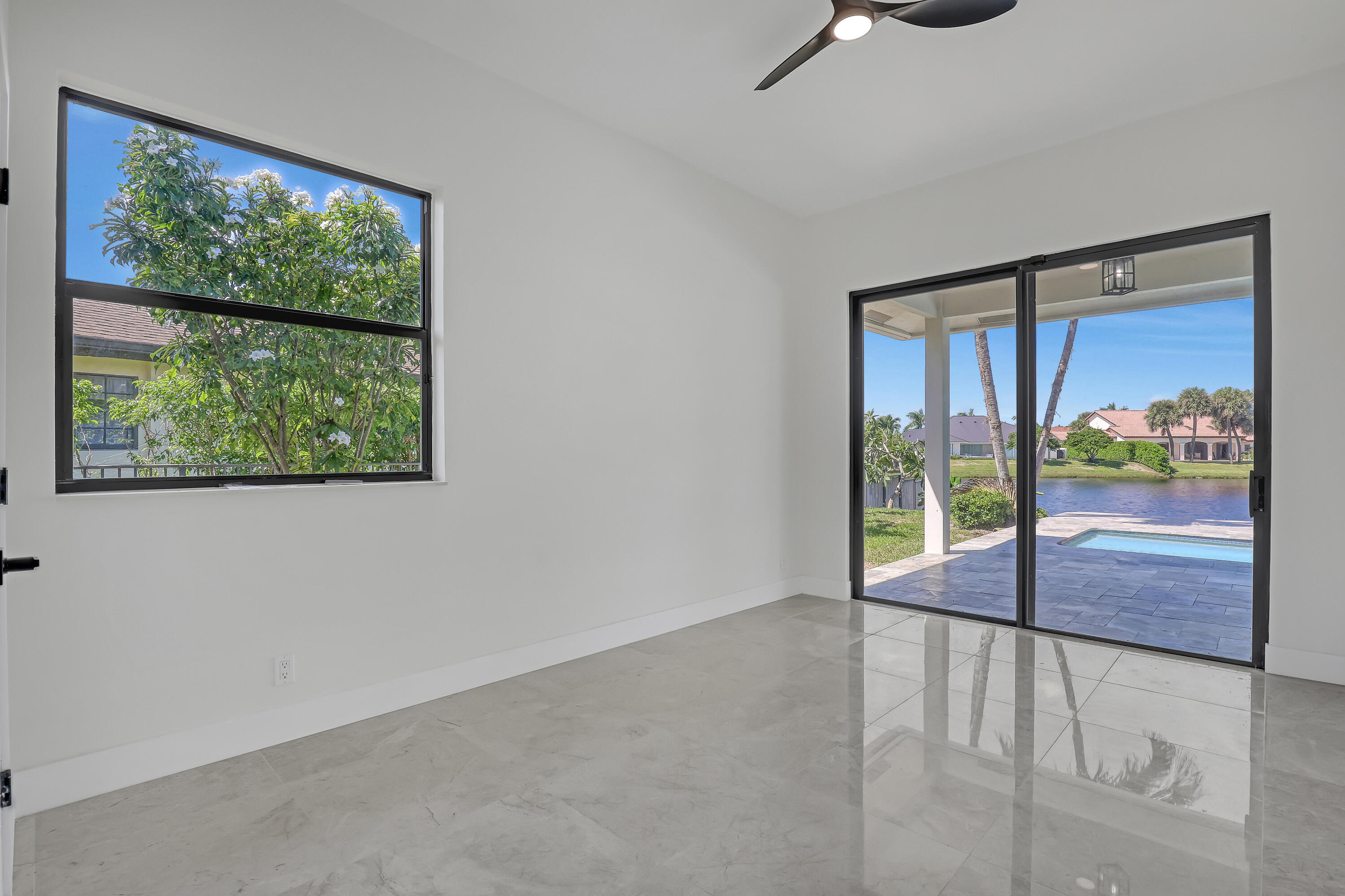161 Apollo Circle Jupiter, FL 33477 - Photo 29 of 60 a view of an empty room with wooden floor and a window