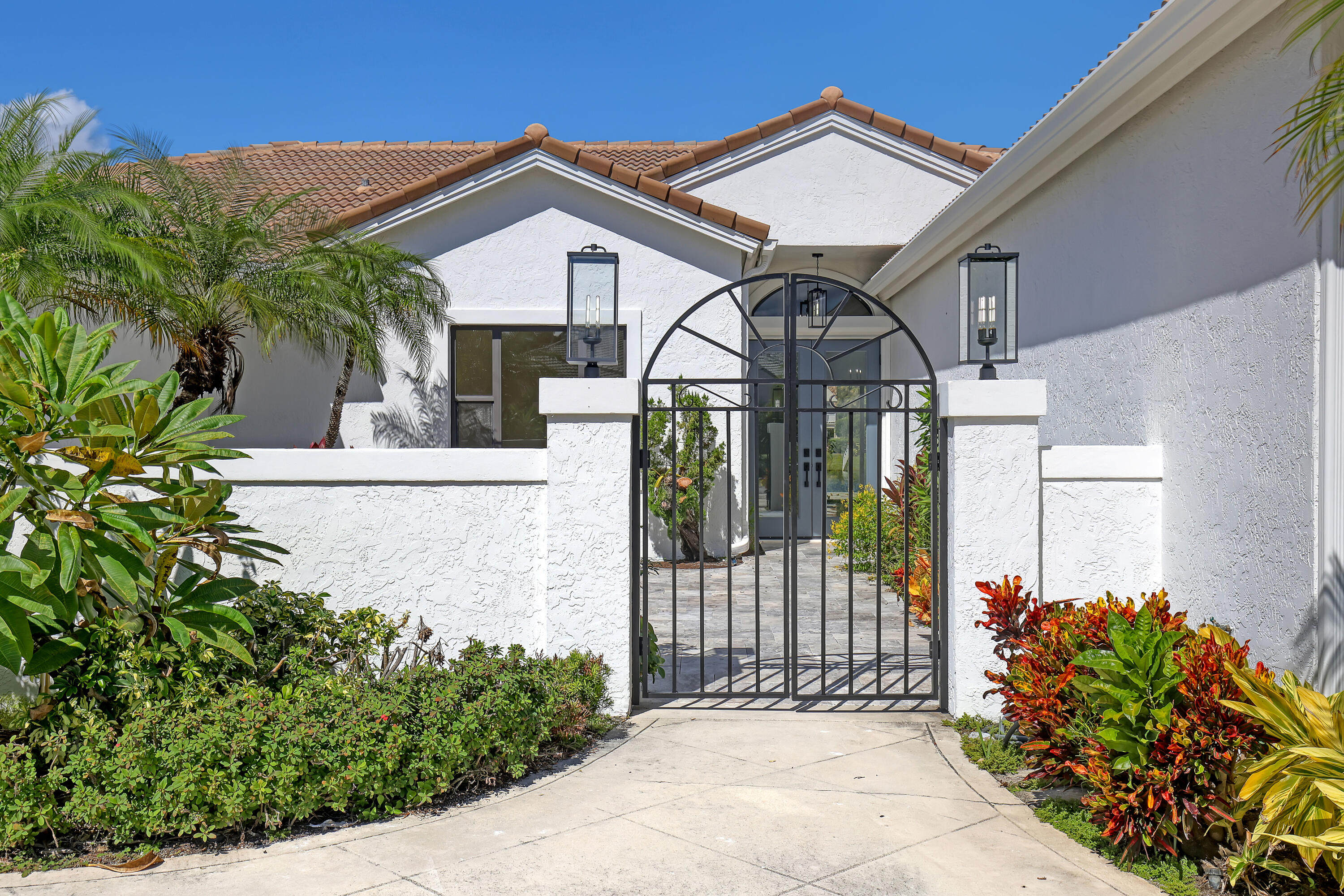 161 Apollo Circle Jupiter, FL 33477 - Photo 34 of 60 a front view of a house with a garden