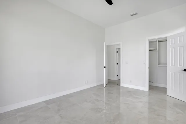 a spacious bathroom with a double vanity sink a large mirror and a bathtub