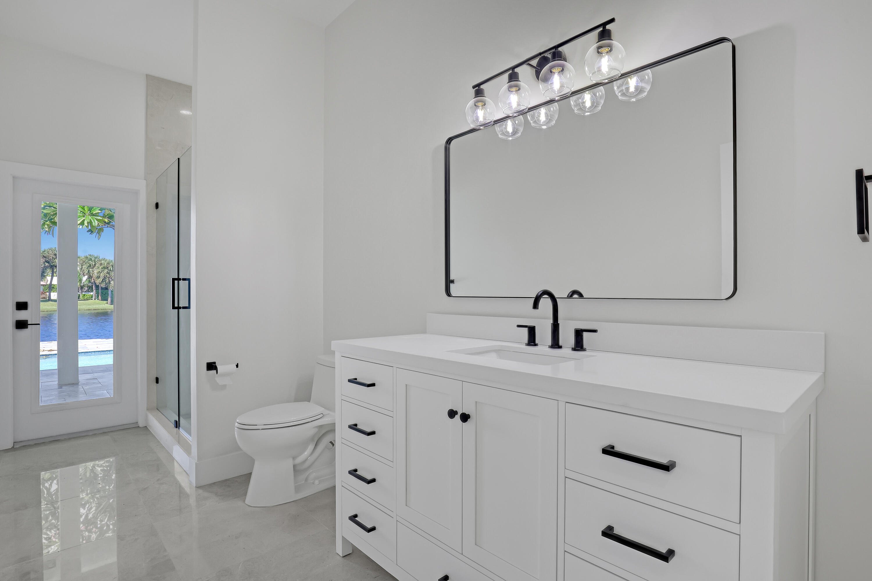 161 Apollo Circle Jupiter, FL 33477 - Photo 44 of 60 a bathroom with a toilet sink and mirror