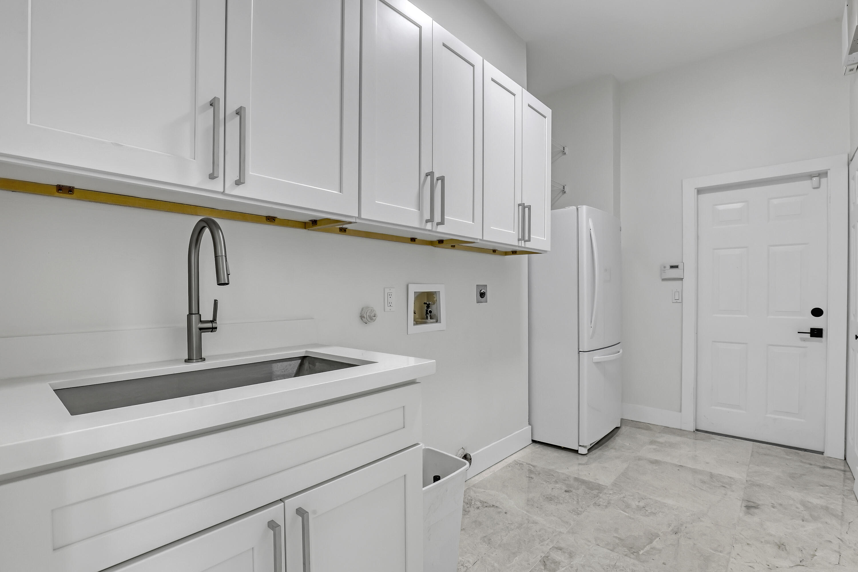 161 Apollo Circle Jupiter, FL 33477 - Photo 59 of 60 a kitchen with stainless steel appliances granite countertop white cabinets and sink