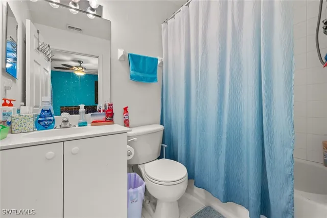 a white toilet sitting next to a bathroom sink