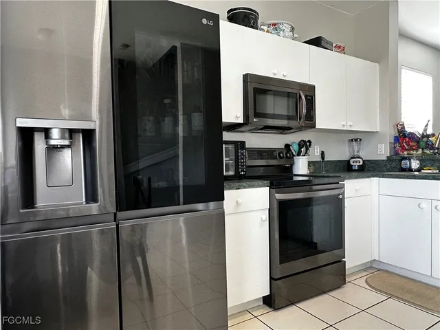 a kitchen with a refrigerator and a stove