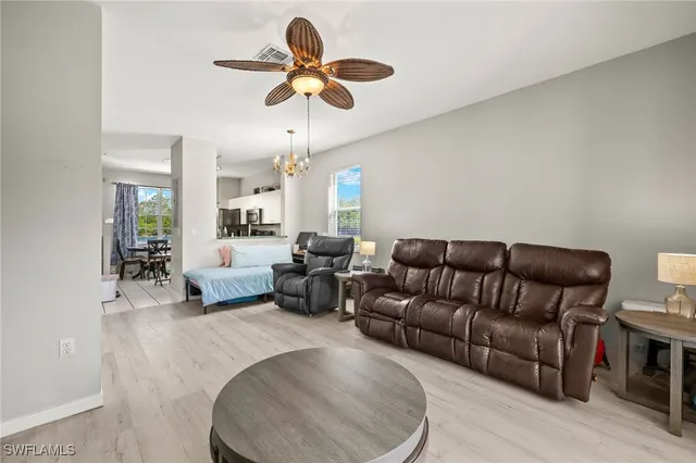 a living room with furniture ceiling fan and a rug
