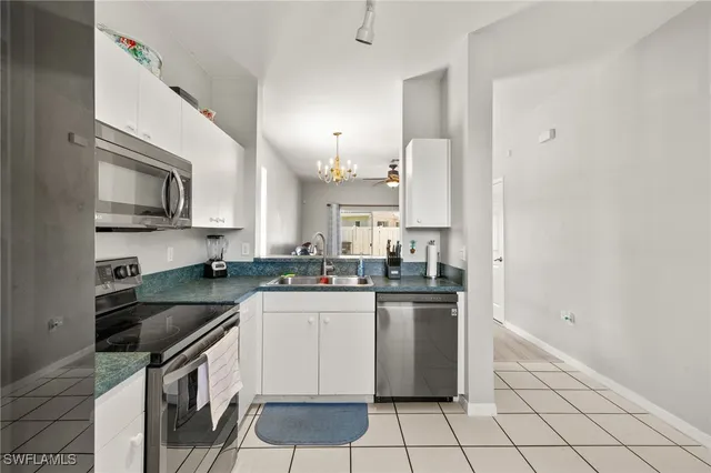 a kitchen with a sink a stove and cabinets