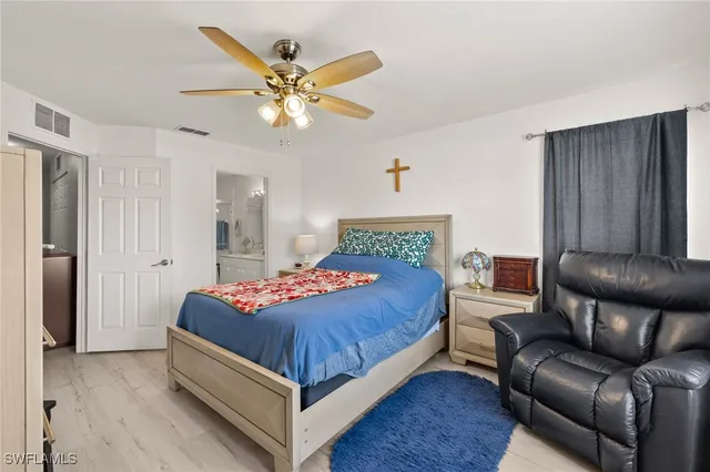 a bedroom with a bed couch and window