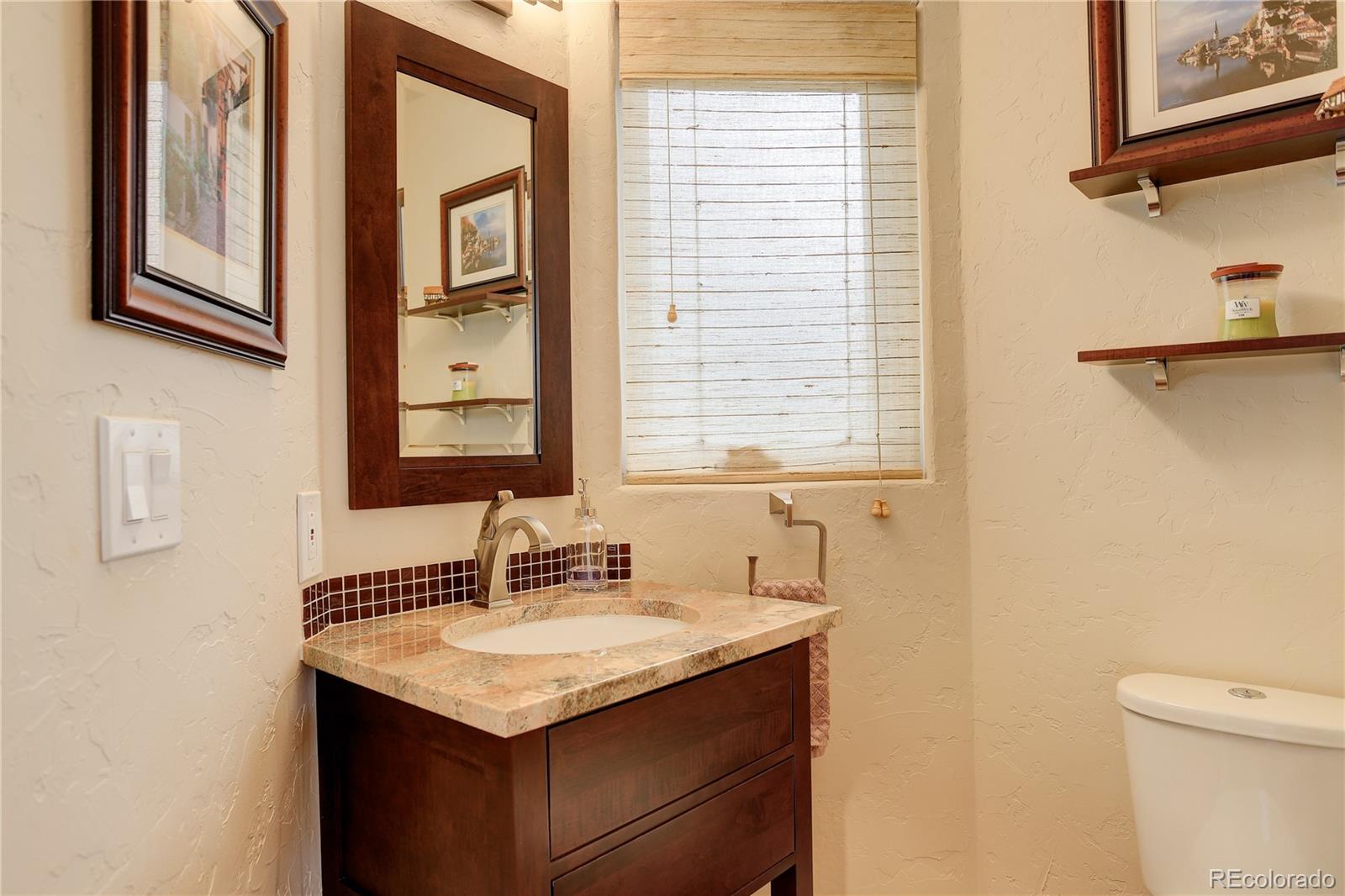 2420 Juniper Court Golden, CO 80401 - Photo 12 of 48 a bathroom with a granite countertop sink and a mirror