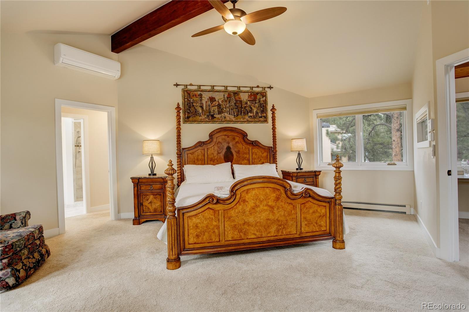 2420 Juniper Court Golden, CO 80401 - Photo 16 of 48 a bedroom with a bed and a chandelier