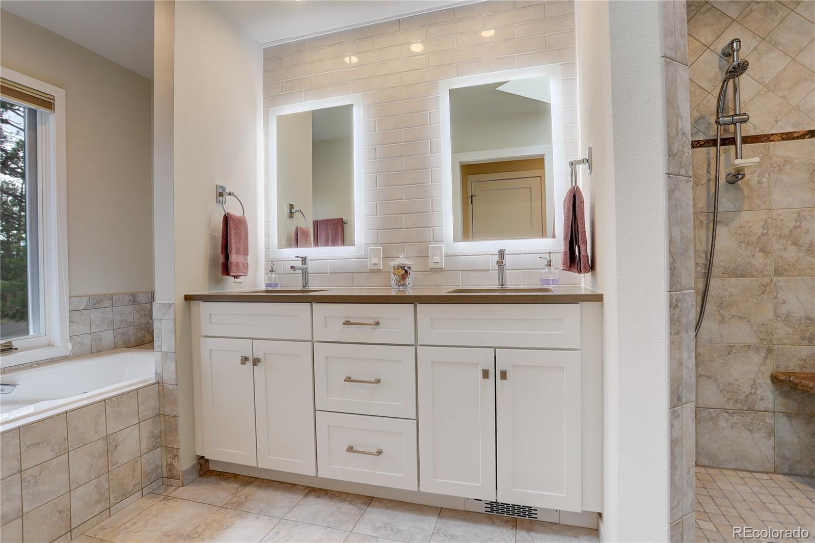 2420 Juniper Court Golden, CO 80401 - Photo 18 of 48 a bathroom with a granite countertop sink mirror and double