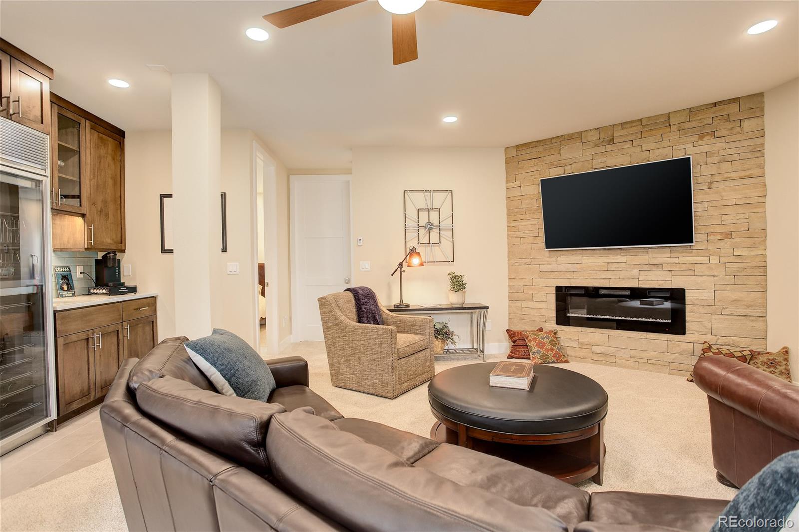 2420 Juniper Court Golden, CO 80401 - Photo 21 of 48 a living room with furniture a fireplace and a flat screen tv