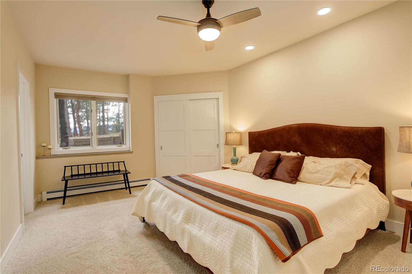 2420 Juniper Court Golden, CO 80401 - Photo 23 of 48 a bedroom with a bed and a chandelier