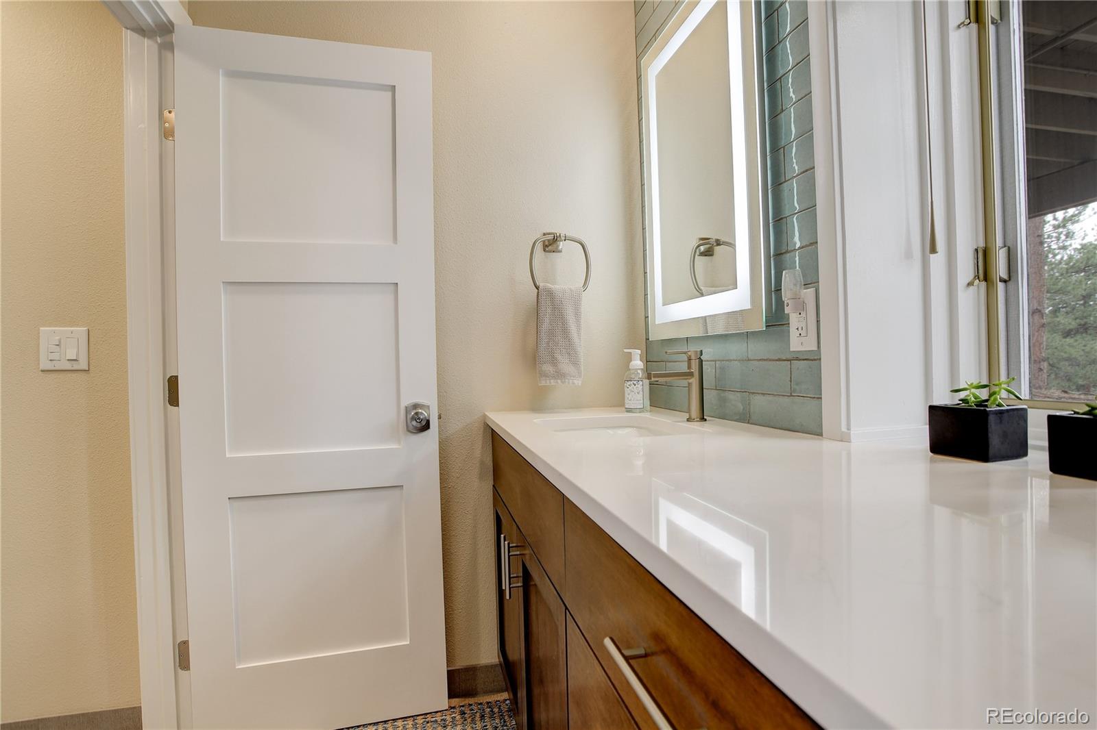 2420 Juniper Court Golden, CO 80401 - Photo 25 of 48 a bathroom with a granite countertop sink and a mirror