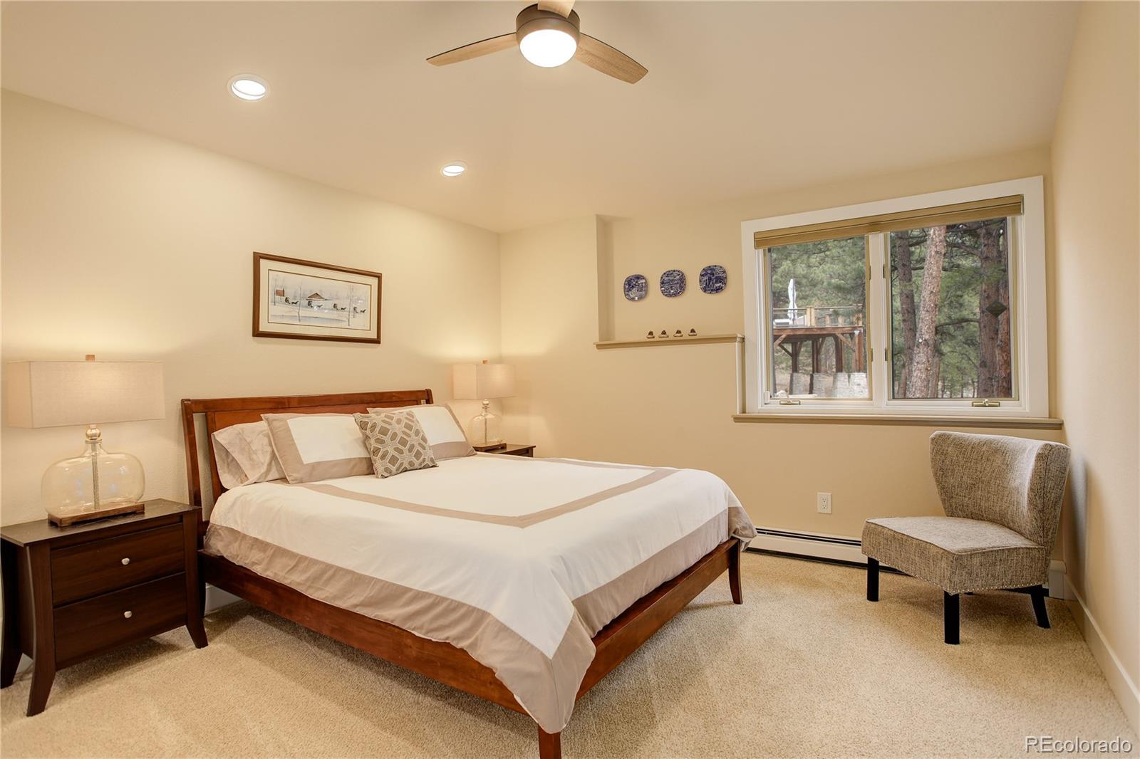2420 Juniper Court Golden, CO 80401 - Photo 29 of 48 a spacious bedroom with a bed and a couch