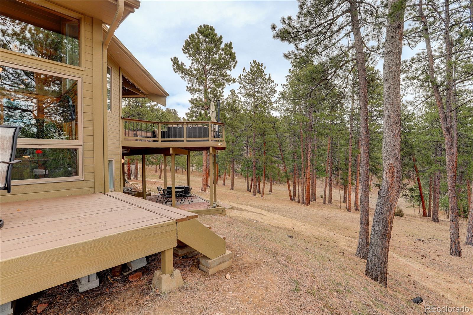2420 Juniper Court Golden, CO 80401 - Photo 40 of 48 a backyard of a house with table and chairs