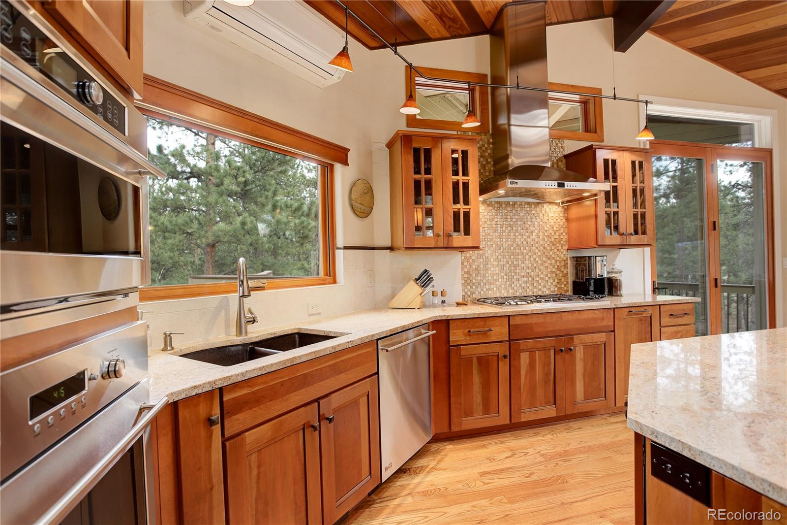 2420 Juniper Court Golden, CO 80401 - Photo 9 of 48 a kitchen with stainless steel appliances granite countertop a sink and wooden cabinets