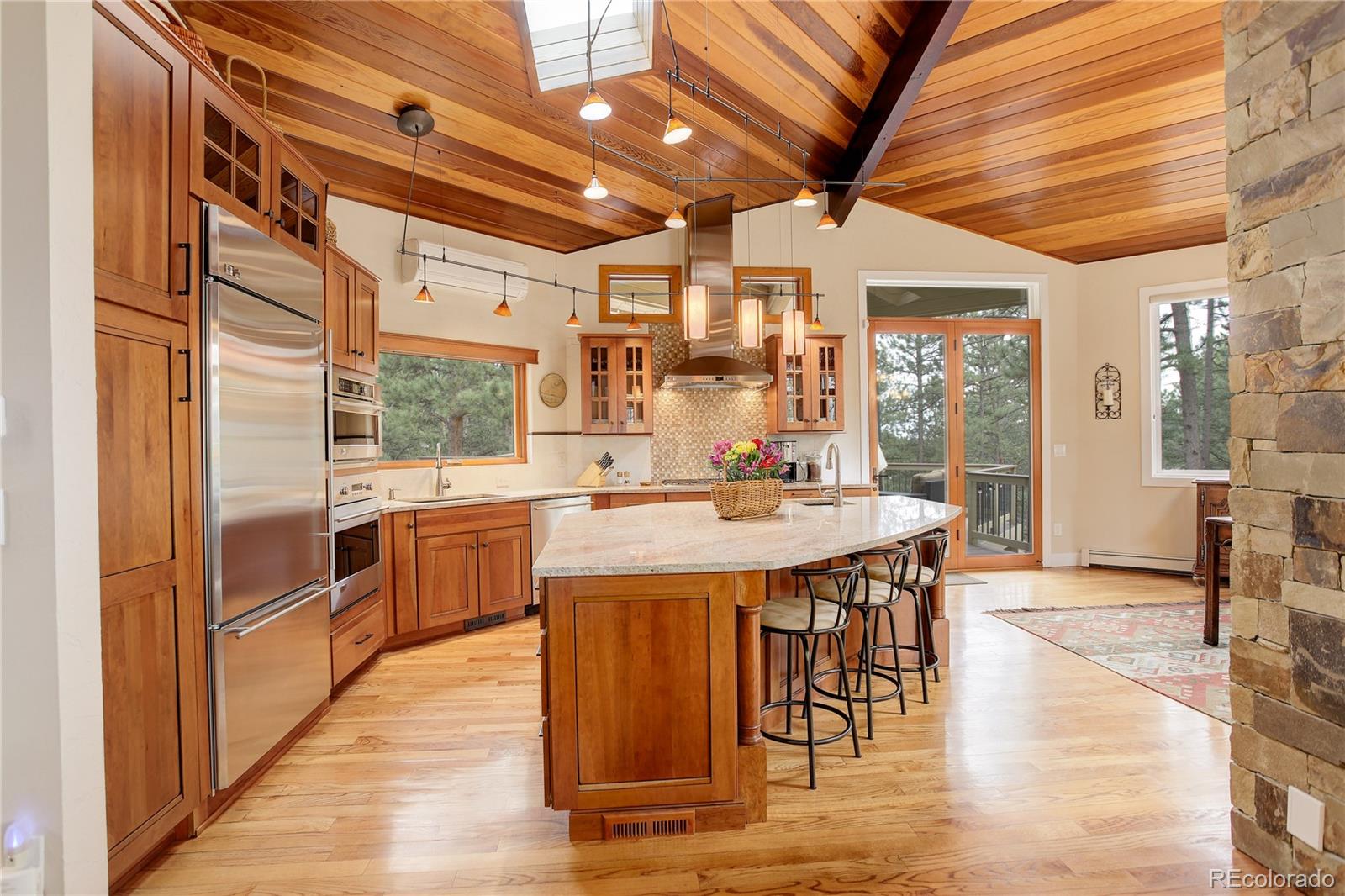 2420 Juniper Court Golden, CO 80401 - Photo 10 of 48 a kitchen with stainless steel appliances granite countertop a sink and wooden cabinets
