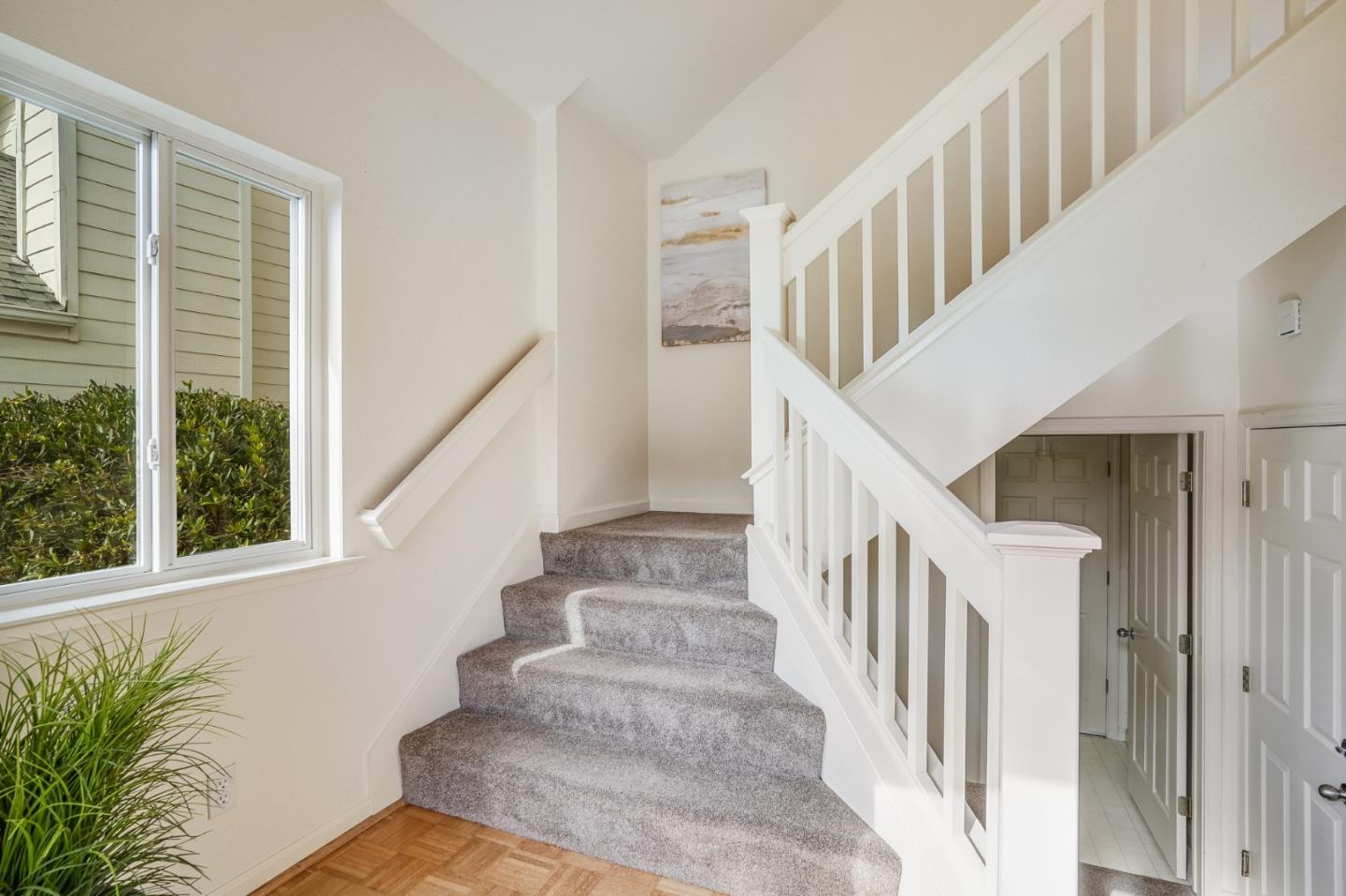 521 Monterey Road, Unit B Pacifica, CA 94044 - Photo 8 of 54 a view of staircase with lots of windows and white walls