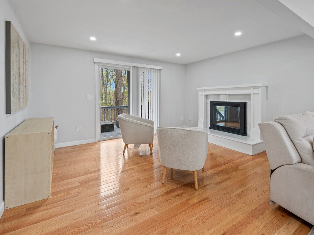 2 Stringer Dam Road Shrewsbury, MA 01545 - Photo 8 of 35 a living room with furniture a fireplace and a wooden floor