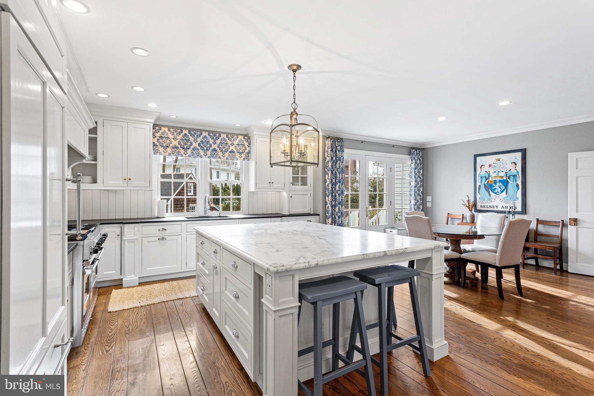 370 Station Avenue Haddonfield, NJ 08033 - Photo 11 of 48 a kitchen with stainless steel appliances granite countertop a kitchen island a stove a table and chairs