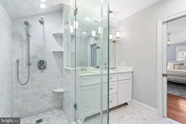 a bathroom with a shower sink and mirror