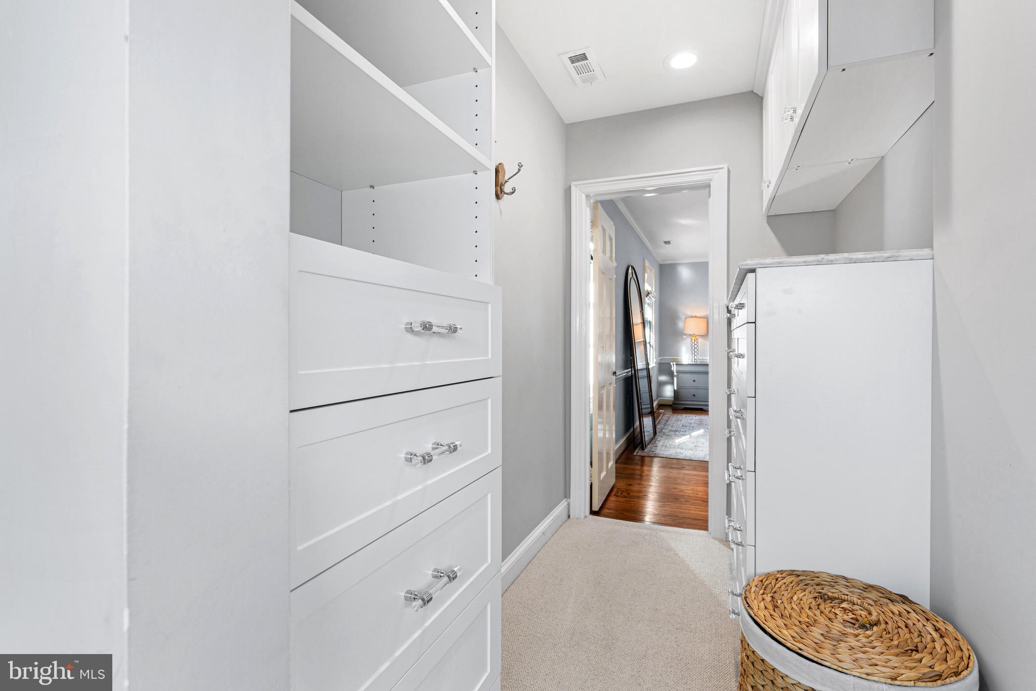 370 Station Avenue Haddonfield, NJ 08033 - Photo 27 of 48 a hallway with white cabinets and wooden floor
