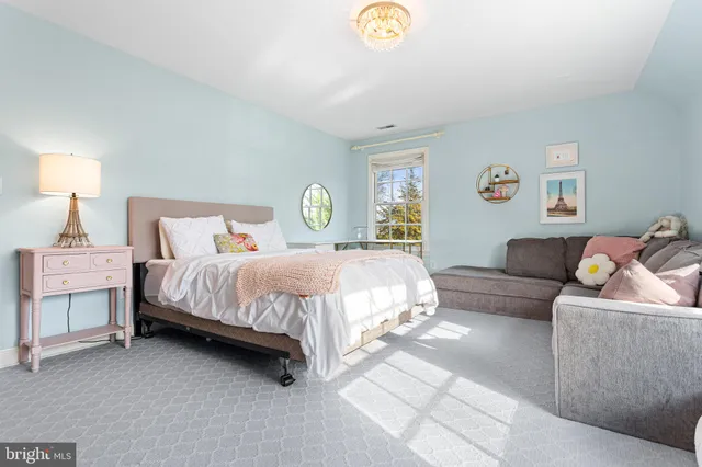 a bedroom with a bed and a couch