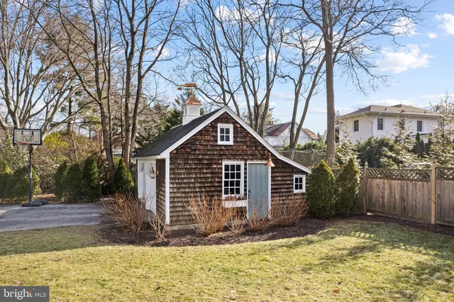 a view of a house with a yard covered with wooden fence