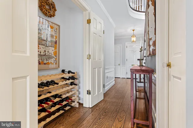 a view of a hallway with wooden floor and entryway